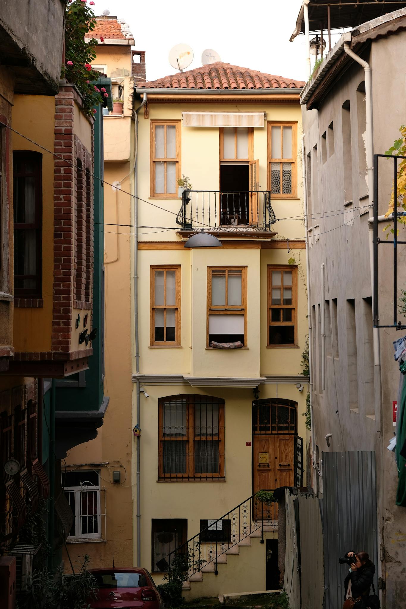 Explore a quaint narrow street with charming historic building facades and vibrant details.